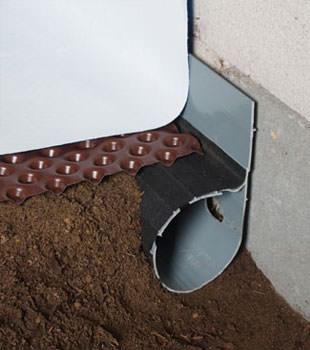 Closeup of a crawl space drainage system installed in Belvidere