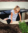 A child crawling out of an egress entryway window system in Hackettstown.