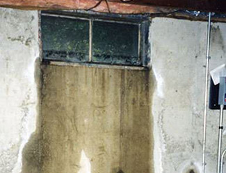 Water pouring out from a basement window in Phillipsburg