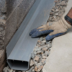 installing a drain tile system in a Heights Bridge home