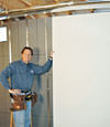 Installing wall panels on top of our basement wall insulation in Hackettstown